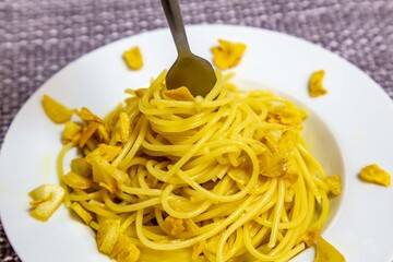 Spaghetti Aglio e Olio with Crispy Garlic on a White Plate