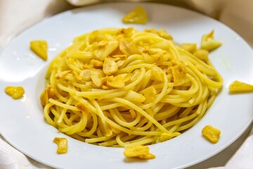 Spaghetti Aglio e Olio with Crispy Garlic on a White Plate