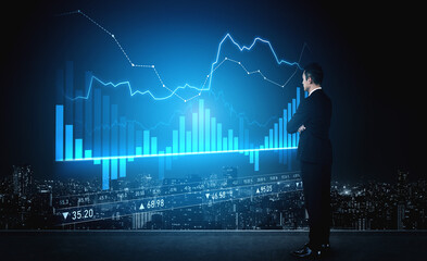 A businessman examines real-time financial data displayed on a digital screen, with graphs and...
