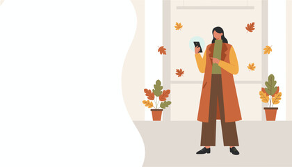 A woman uses her smartphone indoors in warm autumn clothing with fall decor