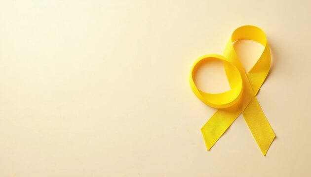 Bright yellow awareness ribbon rests on neutral beige background. Simple symbol represents hope, support, solidarity for many health causes like cancer, endometriosis, childhood cancer. Signifies