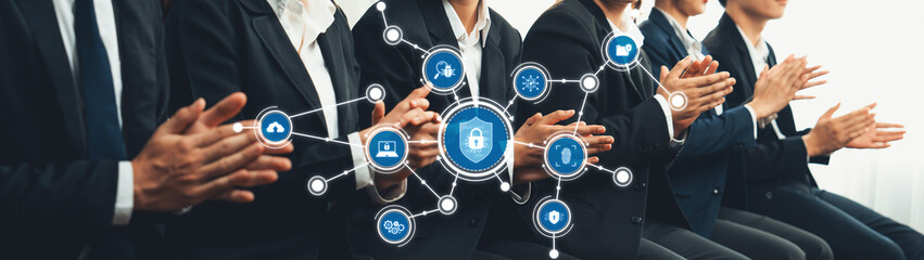 A group of business professionals enthusiastically applauding during a conference, surrounded by digital security and technology icons that symbolize innovation and collaboration. Amity