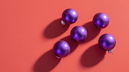 Purple matte christmas baubles arranged on a vibrant red background, casting long shadows, symbolizing holiday cheer and festive decoration with modern appeal