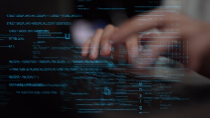 A close-up view of a programmer hands actively typing on a laptop surrounded by flowing lines of code, symbolizing innovation and modern digital development in technology. Xenic