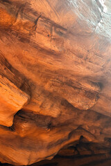 Close-up view of textured red sandstone rock formation in a cave