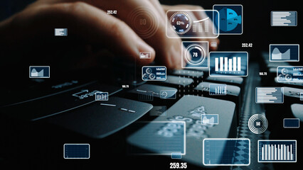 Close-up view of hands typing on a keyboard with digital data overlay, showcasing analytics visualizations and modern technology in a workspace setting. Xenic