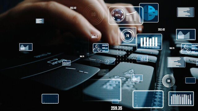 Close-up view of hands typing on a keyboard with digital data overlay, showcasing analytics visualizations and modern technology in a workspace setting. Xenic
