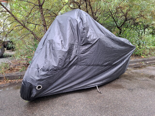 Black cover on parked motorbike © Harmony Video Pro