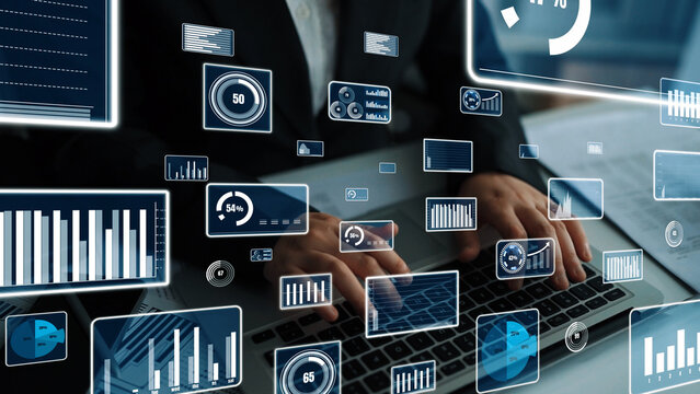 A business professional engages with a laptop in a modern workspace, analyzing digital data visualizations and statistics to enhance decision-making processes. Xenic - Powered by Adobe