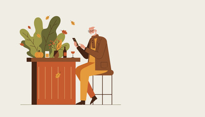 Elderly man relaxing and texting on phone at an autumn bar or cafe