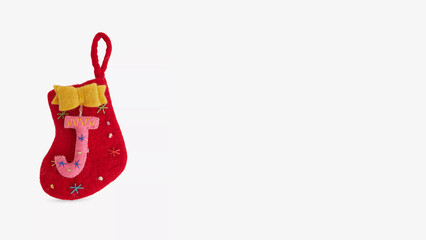 Colorful felt Christmas stocking ornament with a letter J displayed creatively on a clean background.