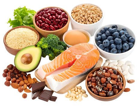 A variety of healthy foods including salmon, berries, nuts, seeds, and vegetables arranged together for a nutritious meal