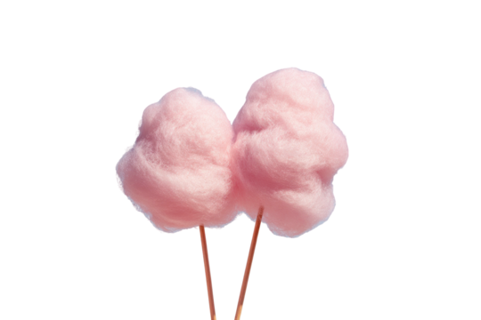 Pink cotton candy on sticks against a black background