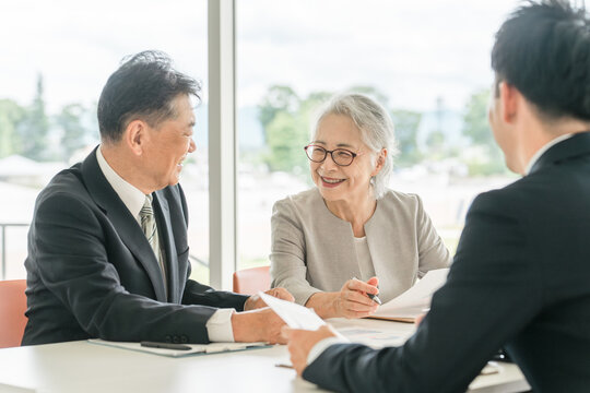 An elderly couple reviewing the proposed documents (asset management, consultation, investment, inheritance)
 - Powered by Adobe