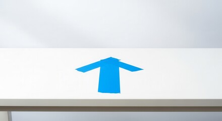 A Bold Blue Arrow Pointing Up On White Surface to Convey Directional Guidance