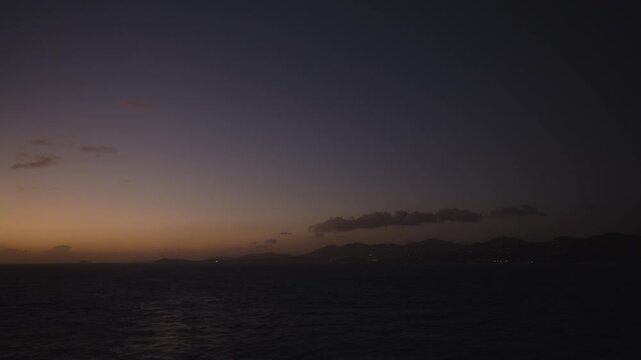Late evening sunset of the Caribbean sea with St. Thomas, USVI on the distant horizon