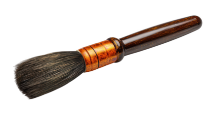 A professional paint brush with a wooden handle and copper ferrule rests on a black surface