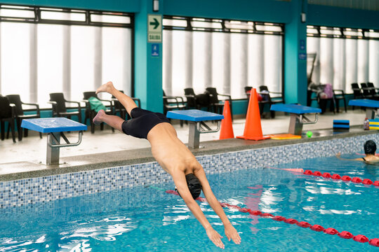 Child diving into swimming pool during swim lesson