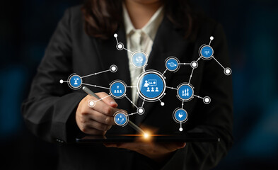 A business professional interacts with a digital tablet, engaging with a network of symbols and icons, representing data visualization and connectivity in today digital landscape. Tessel