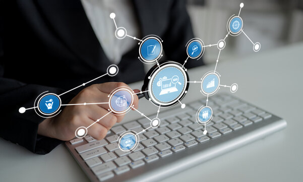 A business professional interacts with digital icons representing data analysis and connectivity on a keyboard, showcasing modern technology in action. Crux