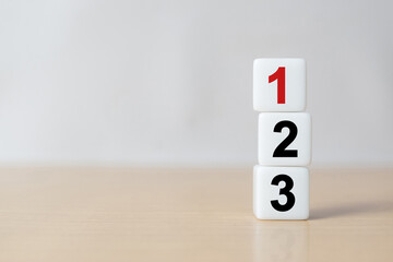 Numbers one, two and three on dice standing on table, plan, priority or winner business concept