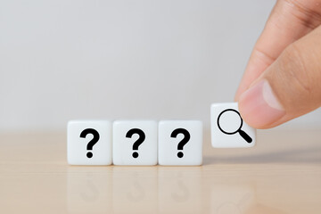 Hand hold magnifying glass and question mark sign icon in dice. Problems and root cause analysis concept. copy space for background or text.