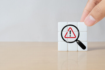 Risk analysis and management concept. Identify potential risks and develop strategies to mitigate. Dice with magnifying glass and triangle caution warning sign. VUCA management concept