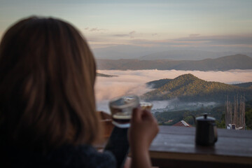 Woman Drinking Coffee with Mountain View