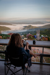 Woman Drinking Coffee with Mountain View