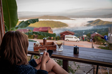 Woman Drinking Coffee with Mountain View