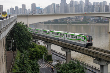 Fototapeta premium Chongqing metro train travel on the high rise track in Chongqing city, China