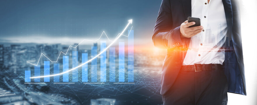 A business professional stands in front of a city skyline, using a smartphone to analyze growth trends illustrated by blue graphs and digital data. Impute