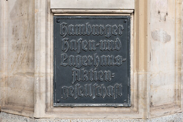 Old sign of the former Hamburger Hafen- und Lagerhaus-Aktiengesellschaft at a building exterior. The company is now known as Hamburger Hafen und Logistik AG (HHLA) and is a big logistics corporation.