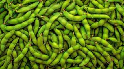 A pile of green soybeans with some brown spots.