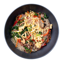 Japchae, Korean stir fried glass noodles with vegetables, pork, soy sauce and sesame oil in cooking pan, Top view	