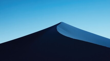 The perfect, sharp line of a single sand dune's crest against a deep, cloudless blue sky, abstract, graphic, and minimalist, focusing on line and color. 
