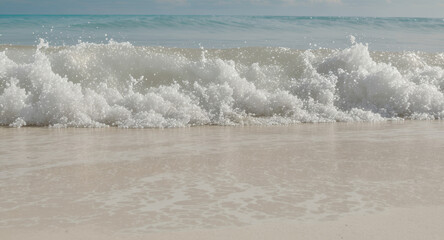 Fototapeta premium Feel the ocean breeze with this wave crashing on the shore, perfect for travel ads or summer promotions and bringing a sense of calm and relaxation