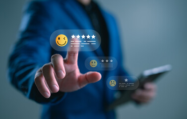 Customer satisfaction rating and feedback concept. Businessman touching emoji with five stars review on virtual interface for service experience, user evaluation, and online reputation system.