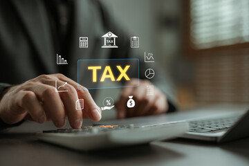 Tax calculation and financial accounting concept. Businessman using calculator and laptop with virtual tax icon, bar chart, percentage, money symbol and document for income and business finance.