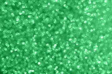 Abstract green glitter sparkle texture background with bokeh