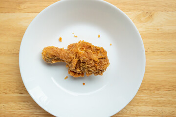 Crispy fried chicken drumstick on white plate