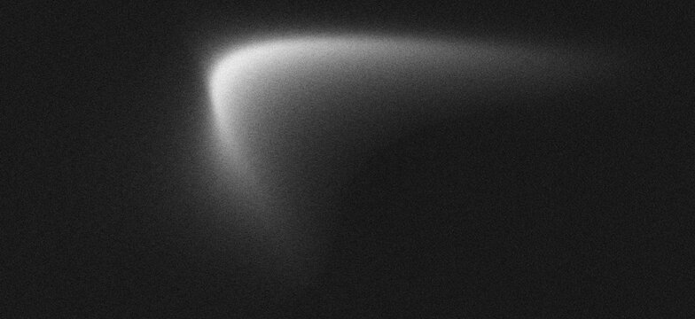 Abstract background with a soft glowing white light leak on a dark, grainy texture. noise background
