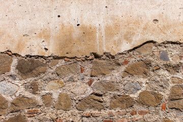Weathered stone and plaster wall texture showcasing natural rock pattern rustic masonry and aged surface detail perfect for backgrounds design elements architecture references and creative texture
