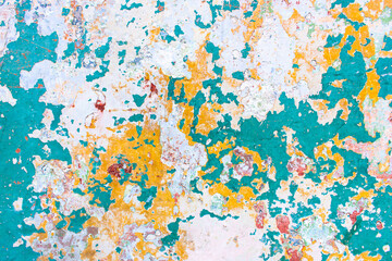 Colorful peeling paint texture with distressed turquoise yellow white layers weathered wall abstract grunge pattern rustic surface cracked paint flakes artistic decay background vibrant chipped
