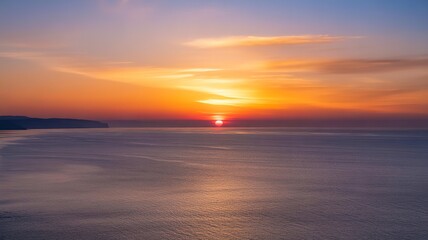 Obraz premium Vibrant sunset over calm ocean waters