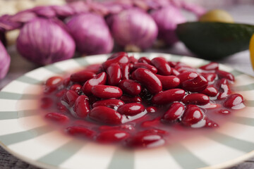 Fresh red kidney beans on a decorative plate with vegetables
