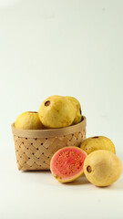 several pink Guava in a basket isolated on white background
