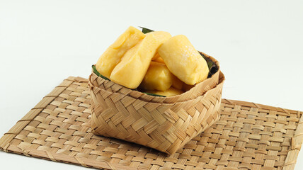 Cassava Tape in a basket on a white background, a traditional Indonesian food, made from cassava with yeast fermentation.
