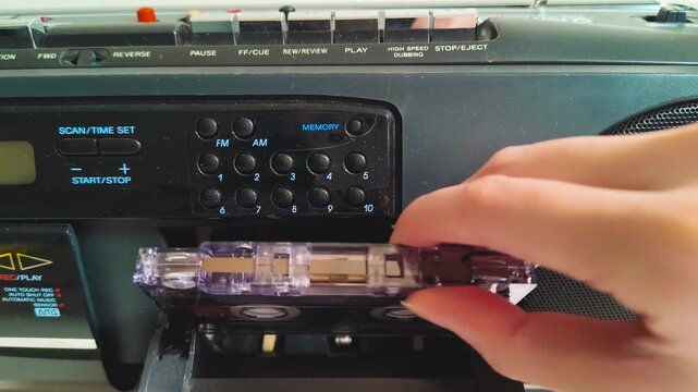 Vintage cassette player in action, finger pressing the stop/eject button, bringing back memories of analog music and retro sound, a nostalgic trip to the golden era of mixtapes