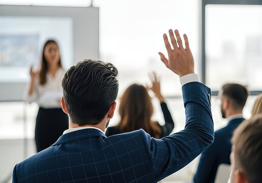 Businessman raising hand to ask a question at a business conference